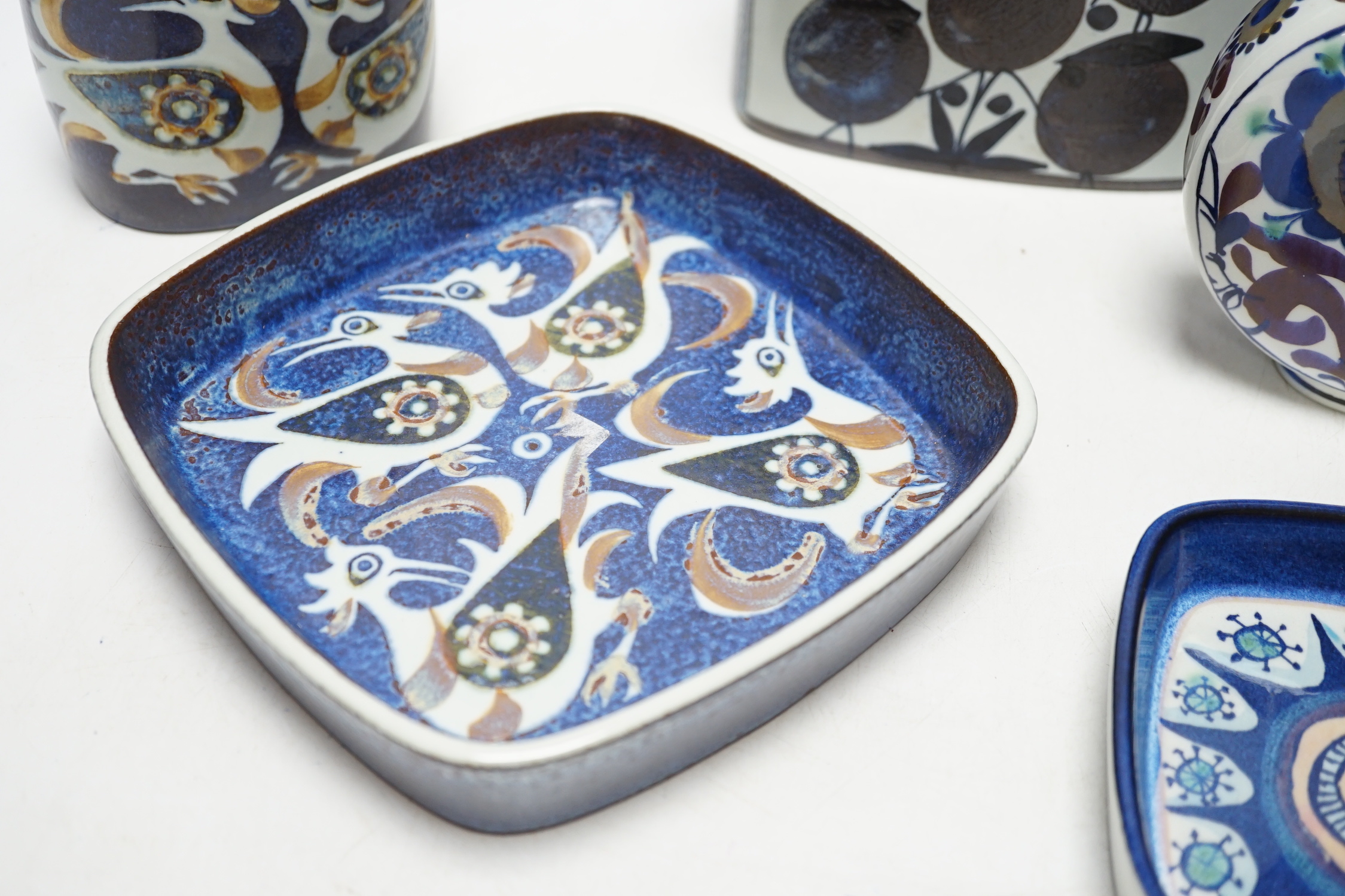 A Royal Copenhagen rectangular section fajance vase and a smaller similar bird decorated vase a circular floral vase and two varying sized square dishes, tallest vase 19cm high